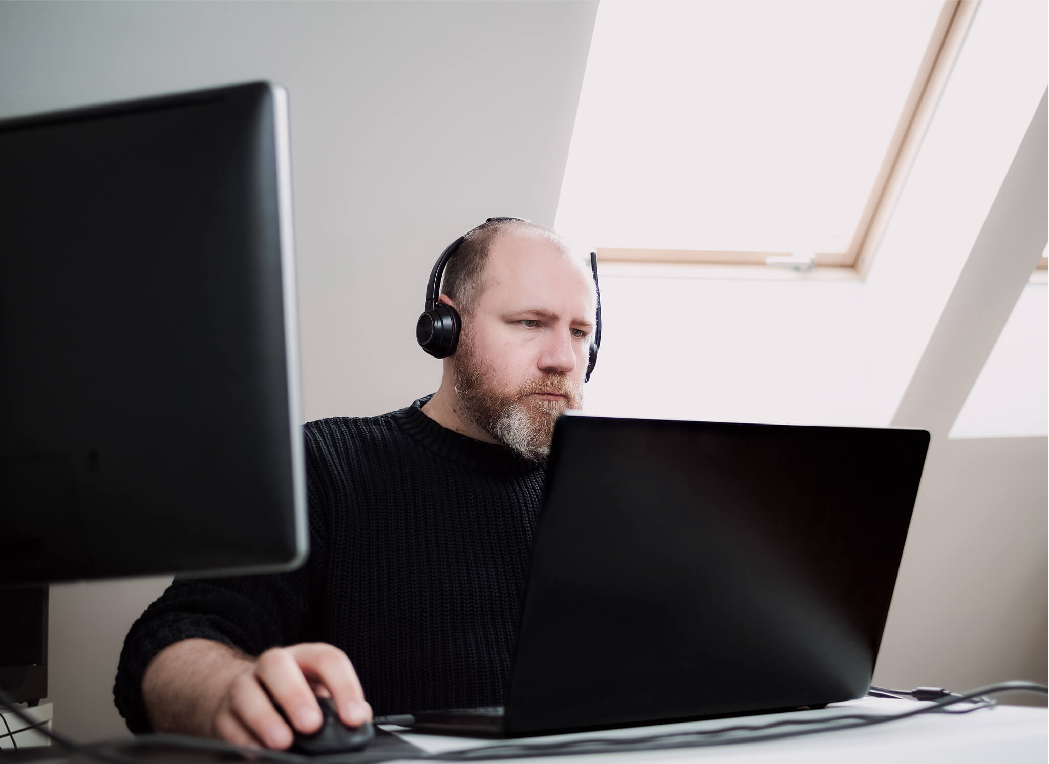 adult-man-remote-working-laptop-using-two-monitors-headphones-from-home-person 1 adult-man-remote-working-laptop-using-two-monitors-headphones-from-home-person 1