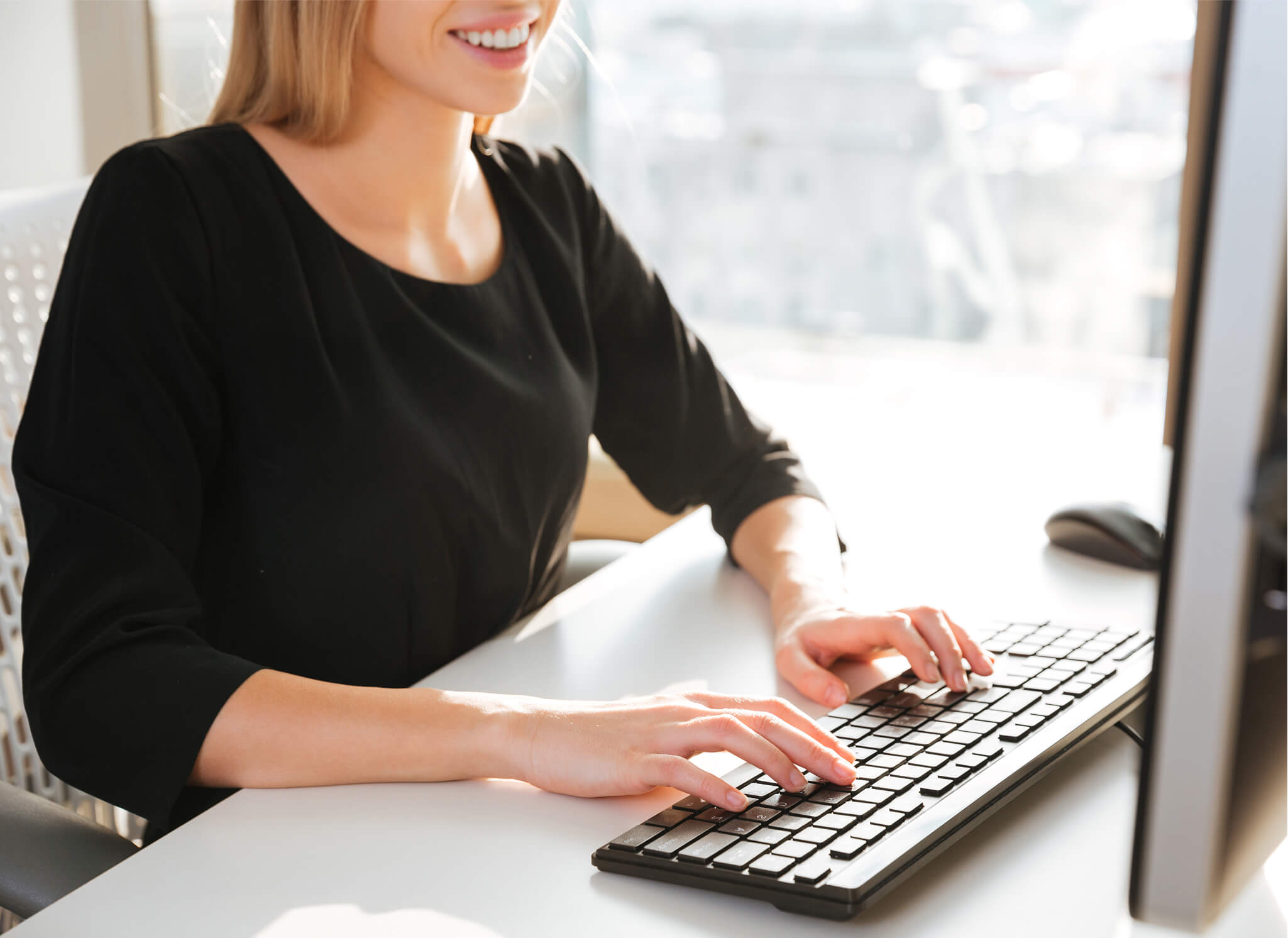 cropped-photo-cheerful-young-woman-worker-sitting-office-while-using-computer 1