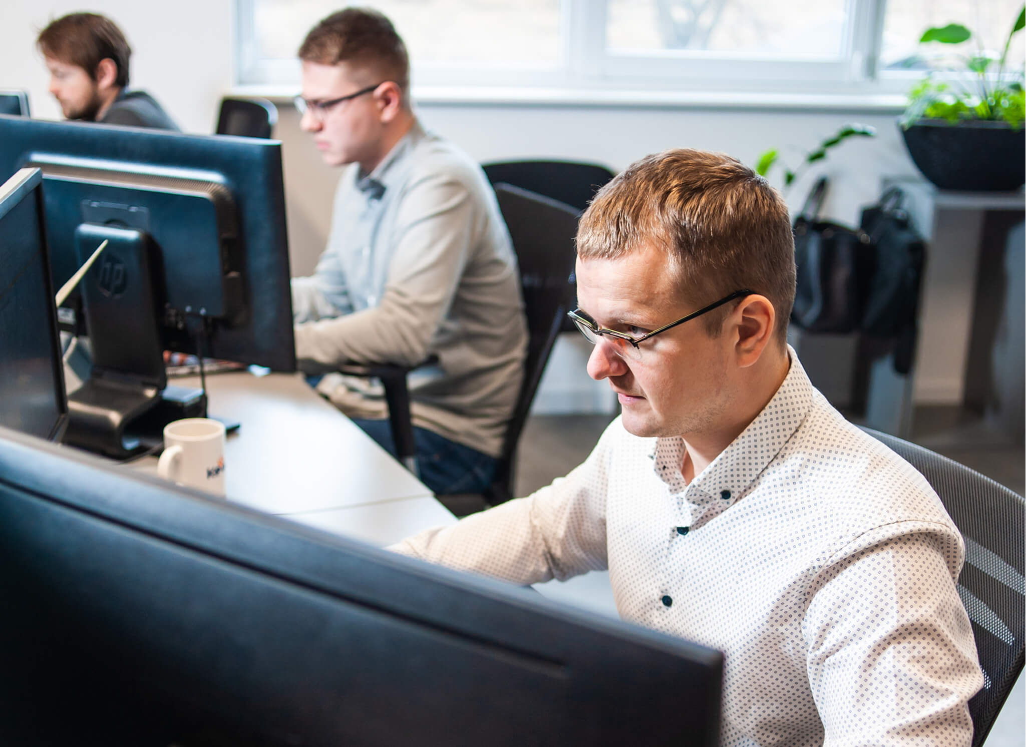 male-office-worker-looking-computer-screen-with-data 1 male-office-worker-looking-computer-screen-with-data 1