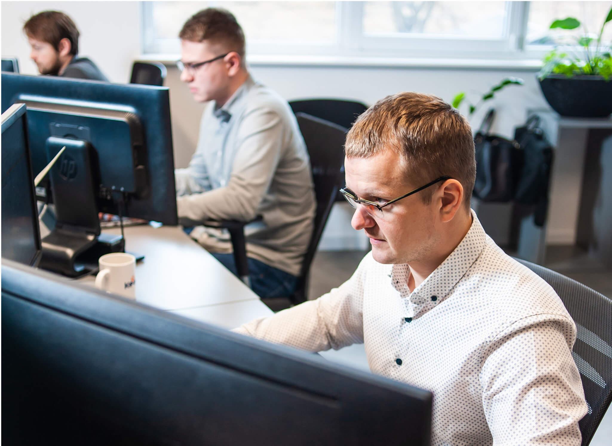 male-office-worker-looking-computer-screen-with-data 1 male-office-worker-looking-computer-screen-with-data 1