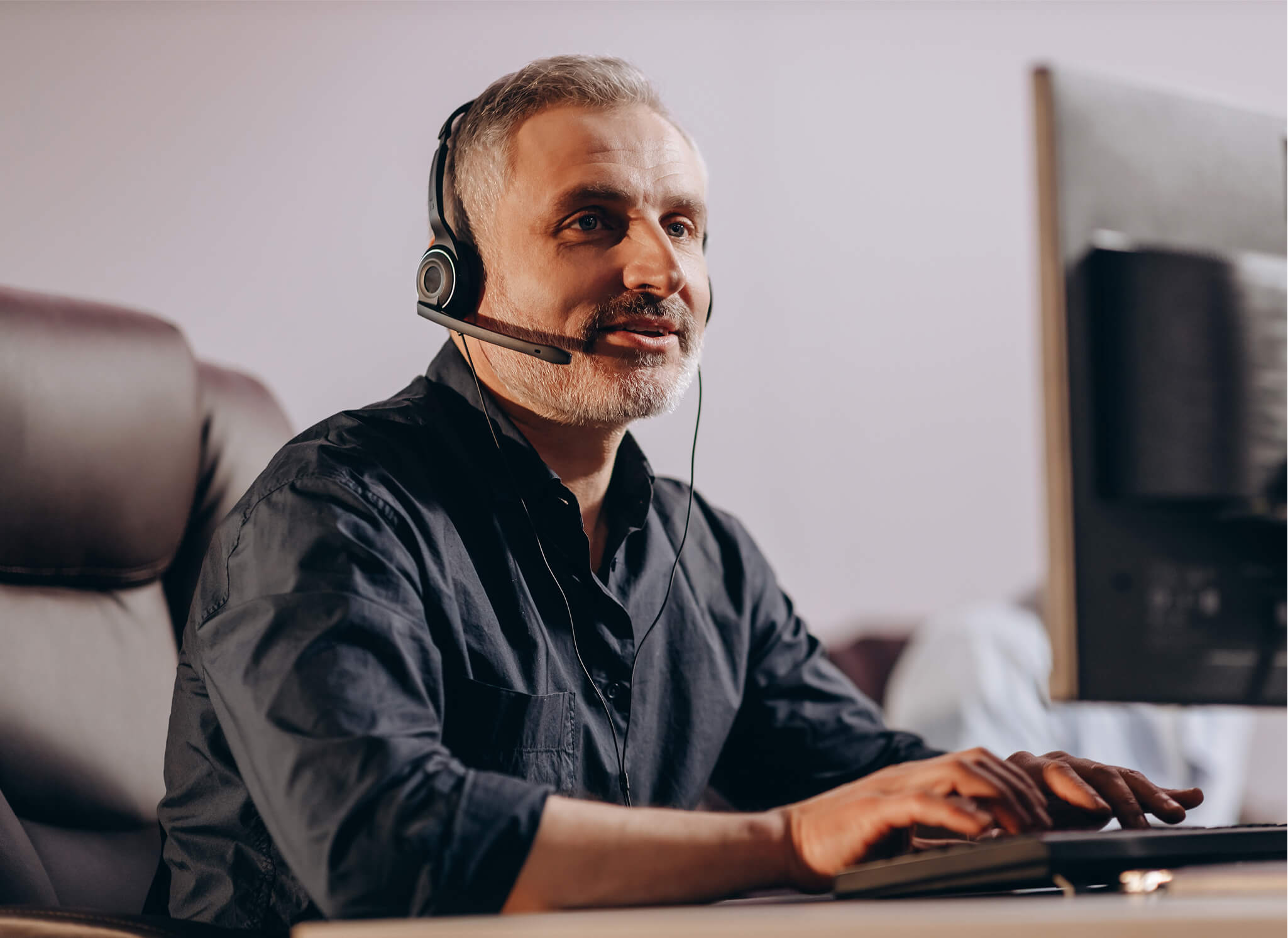 sales-manager-talking-client-via-headset-middleaged-hotline-operator-typing-computer-keyboard-customer-support-agent-office 1 sales-manager-talking-client-via-headset-middleaged-hotline-operator-typing-computer-keyboard-customer-support-agent-office 1